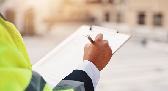 Inspector reviewing plans on site